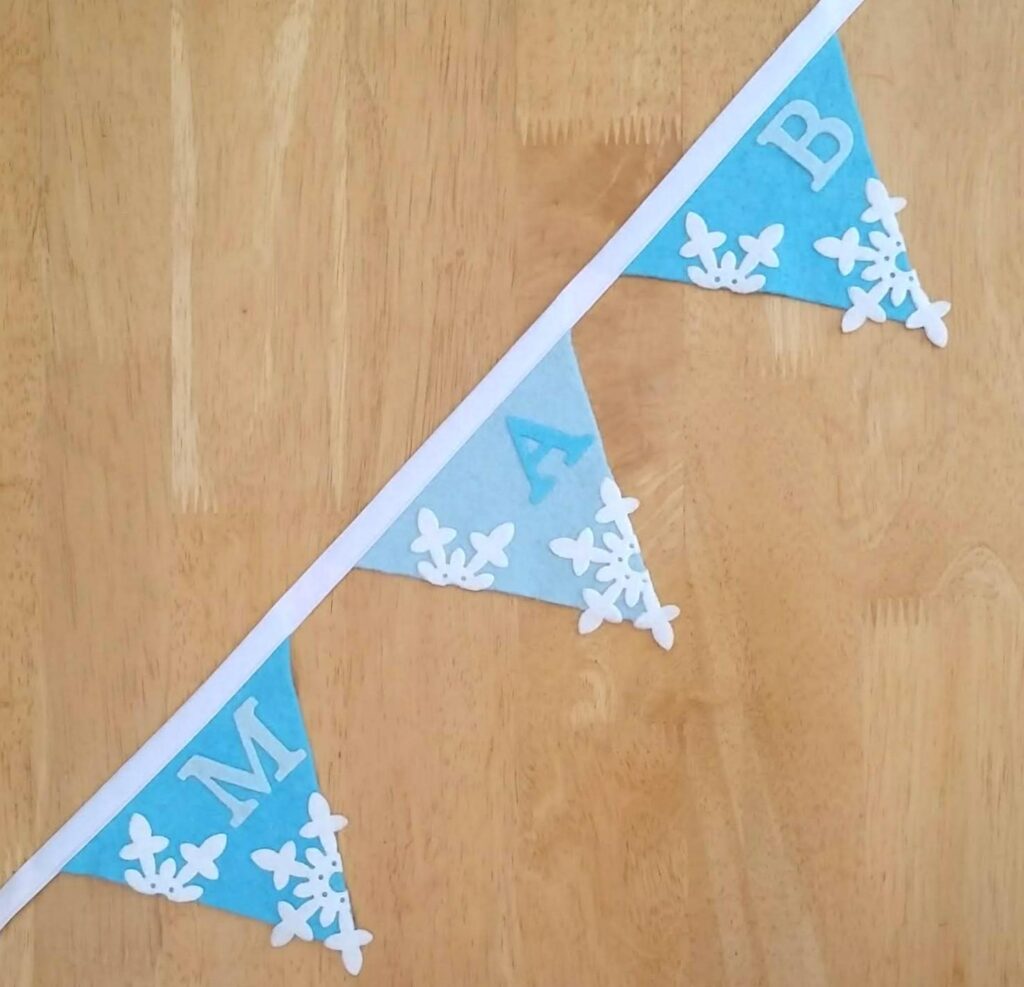 Let it Snow: 5 Ways to Use felt Iron-On Snowflakes Pale blue and turquoise snowflake bunting